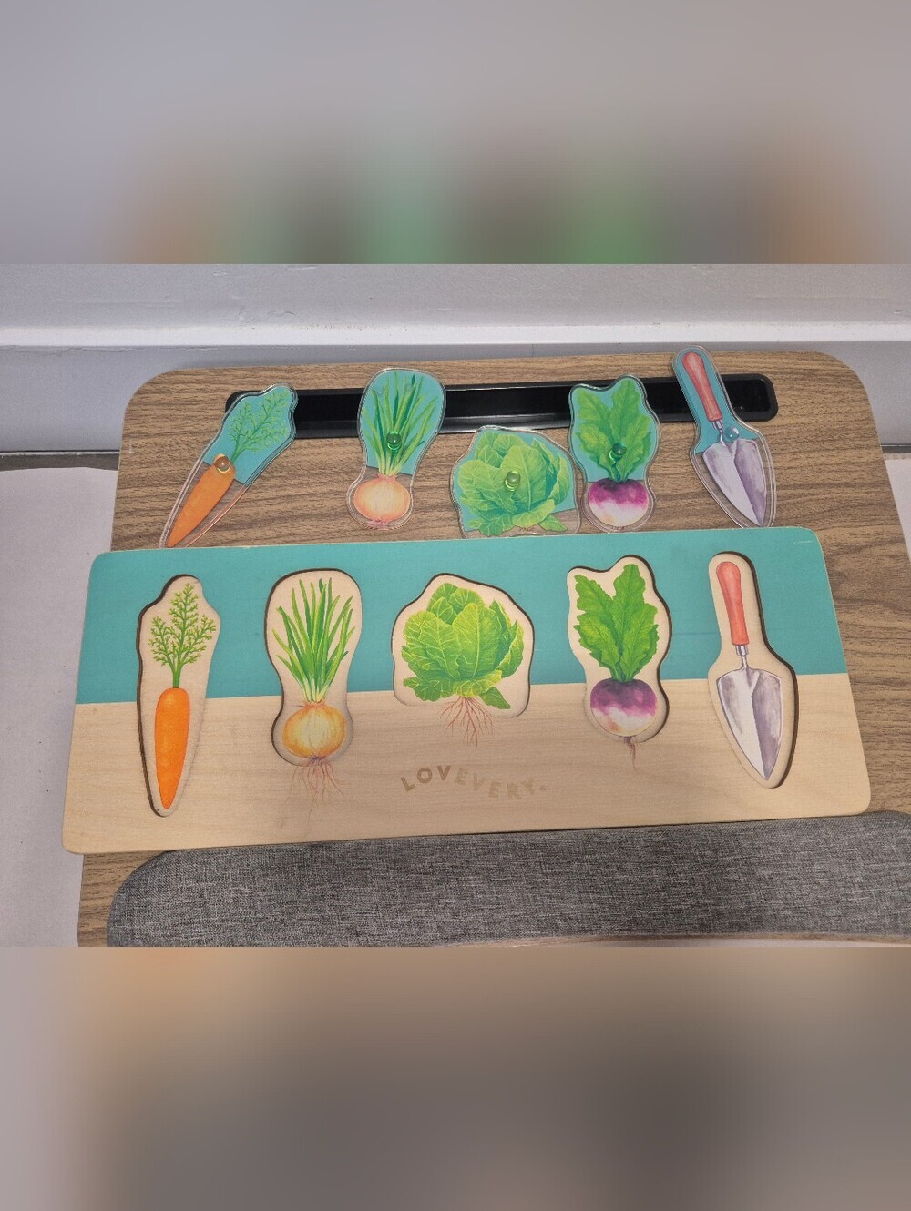 Lovevery Community Garden wooden puzzle with acrylic vegetable pieces.